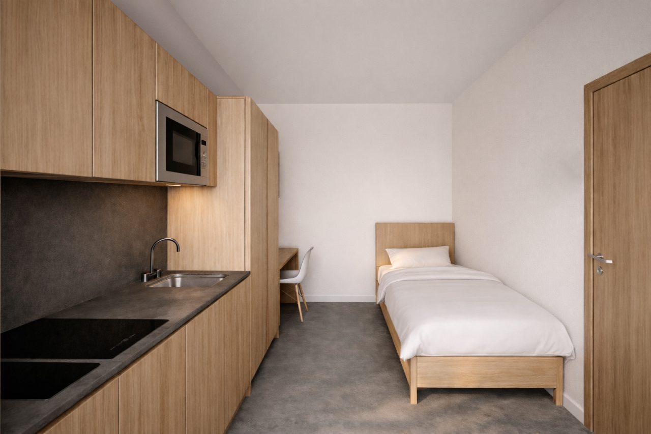 Habitación con cocina integrada y mobiliario de madera